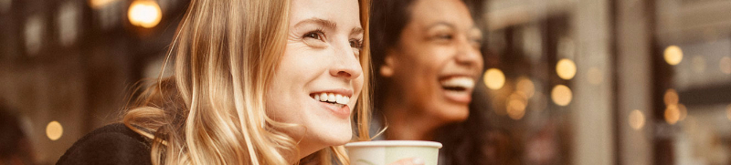 Women having coffee and smiling
