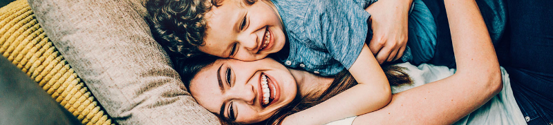 Mom hugging son with smiles