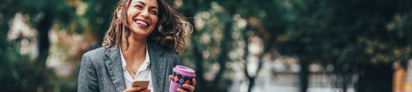 Woman with coffee and cell phone