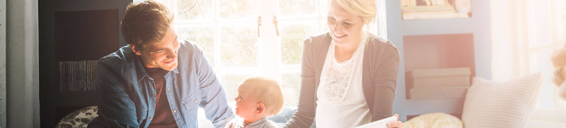 Family with toddler sitting on window seat