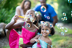 Young family blowing bubbles