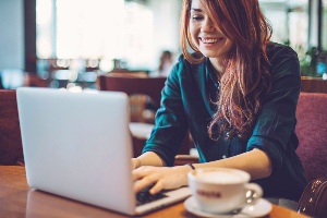 Woman on laptop in a coffee shop