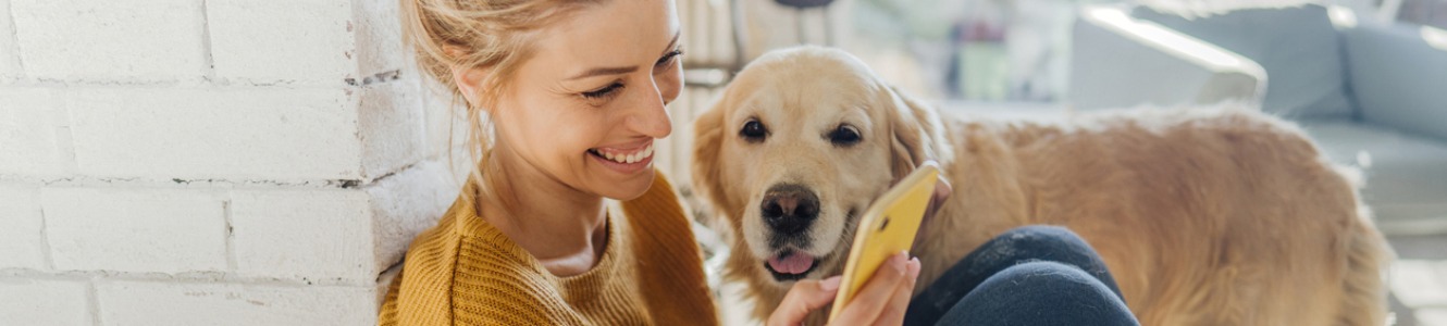 Woman with dog and cell phone