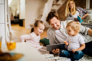 Family with children looking at tablet