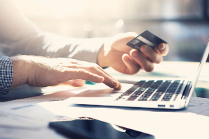 Man on laptop with credit card