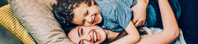 Mom hugging son with smiles