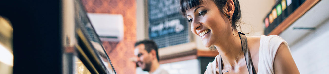 Woman working at small cafe