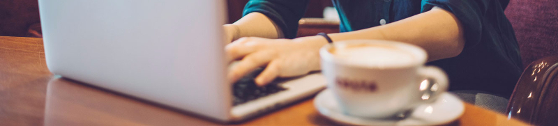 Woman on laptop in a coffee shop
