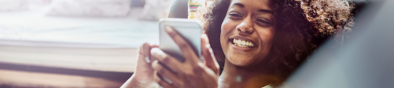 Woman on cell phone sitting on couch