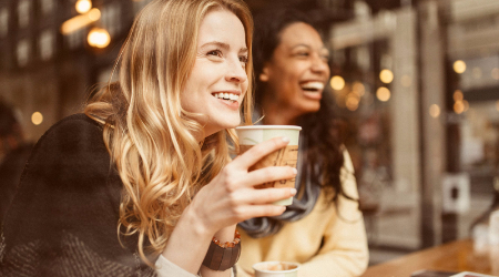 Women having coffee and smiling