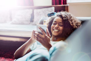 Woman on cell phone sitting on couch