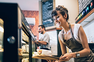 Woman filling tray at cafe