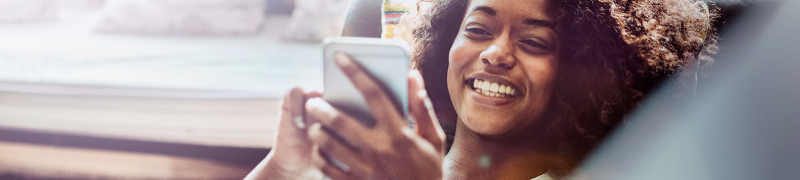 Woman on cell phone sitting on couch