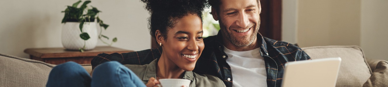 Couple with coffee and tablet