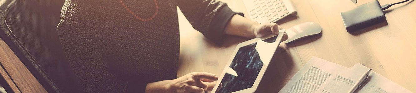 Woman on a tablet at desk