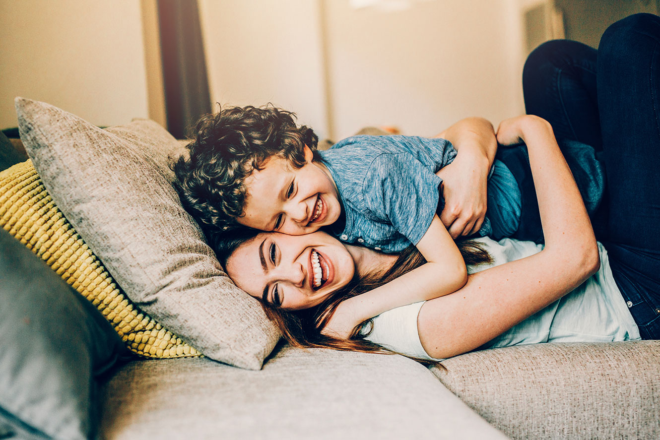 Mom hugging son with smiles