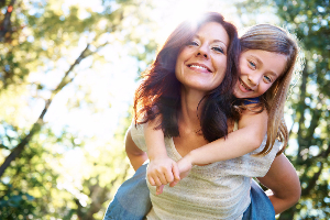 Mother and daughter surrounded by trees