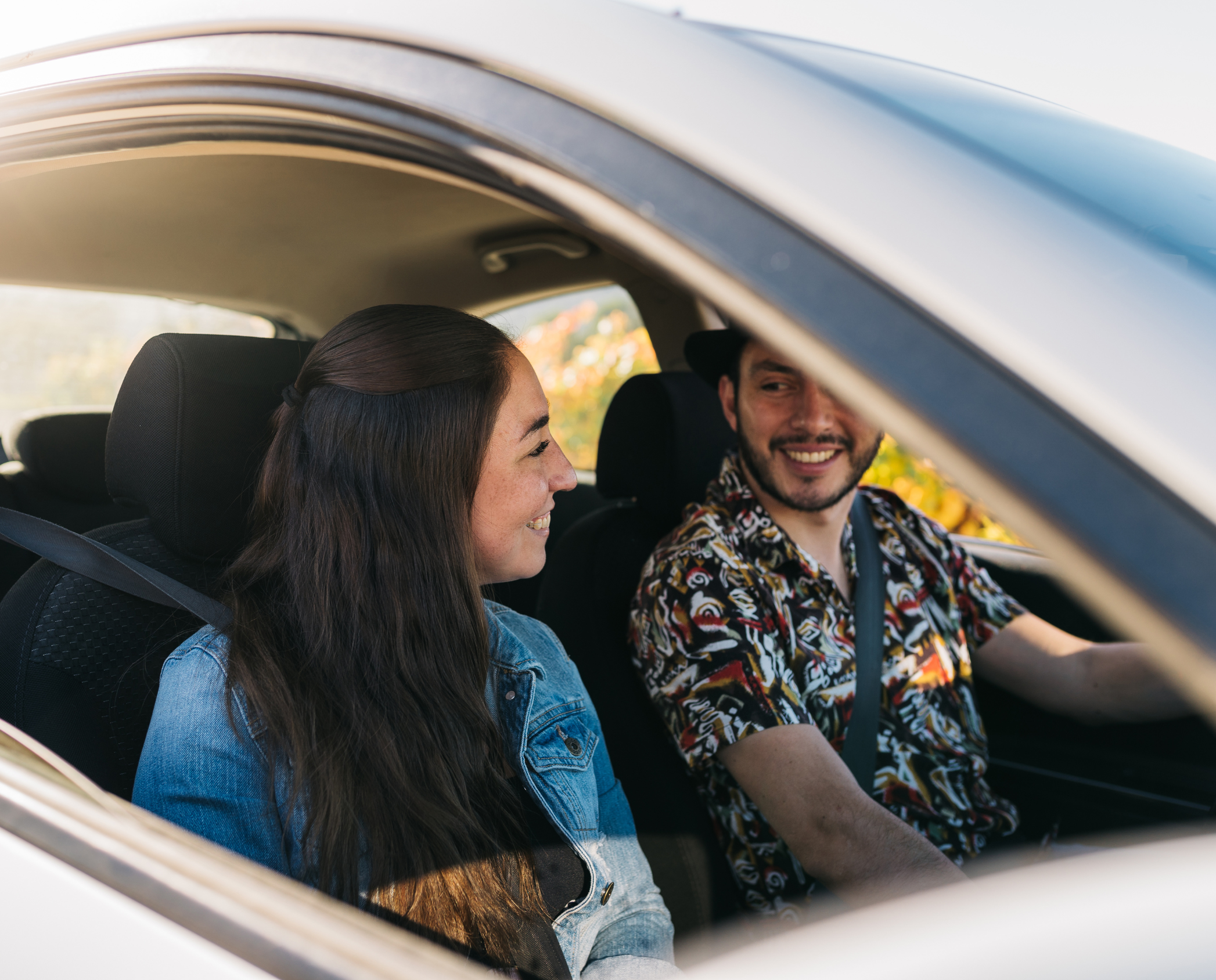 Couple smiling in new car