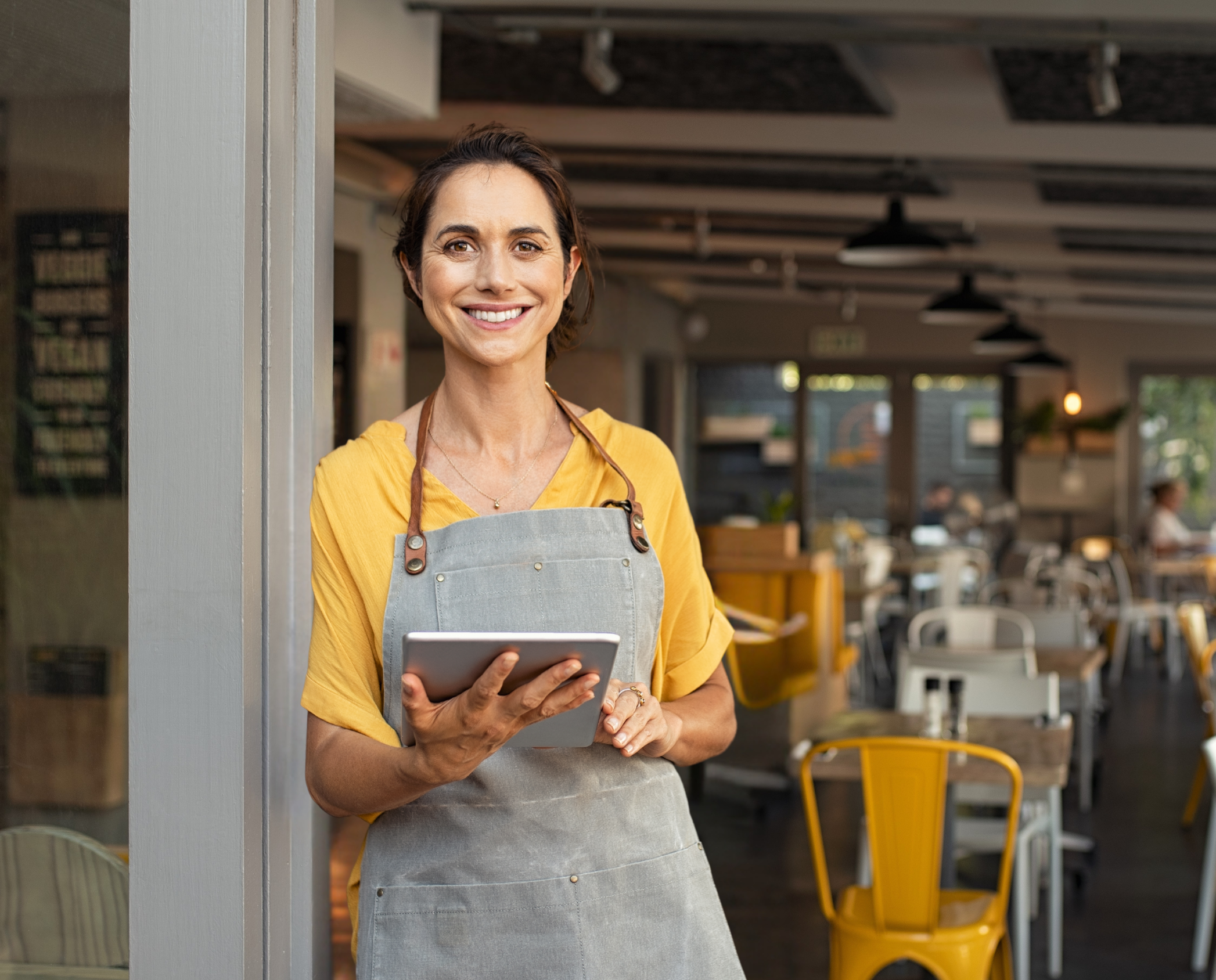 Small Business owner smiling in her restaurant 