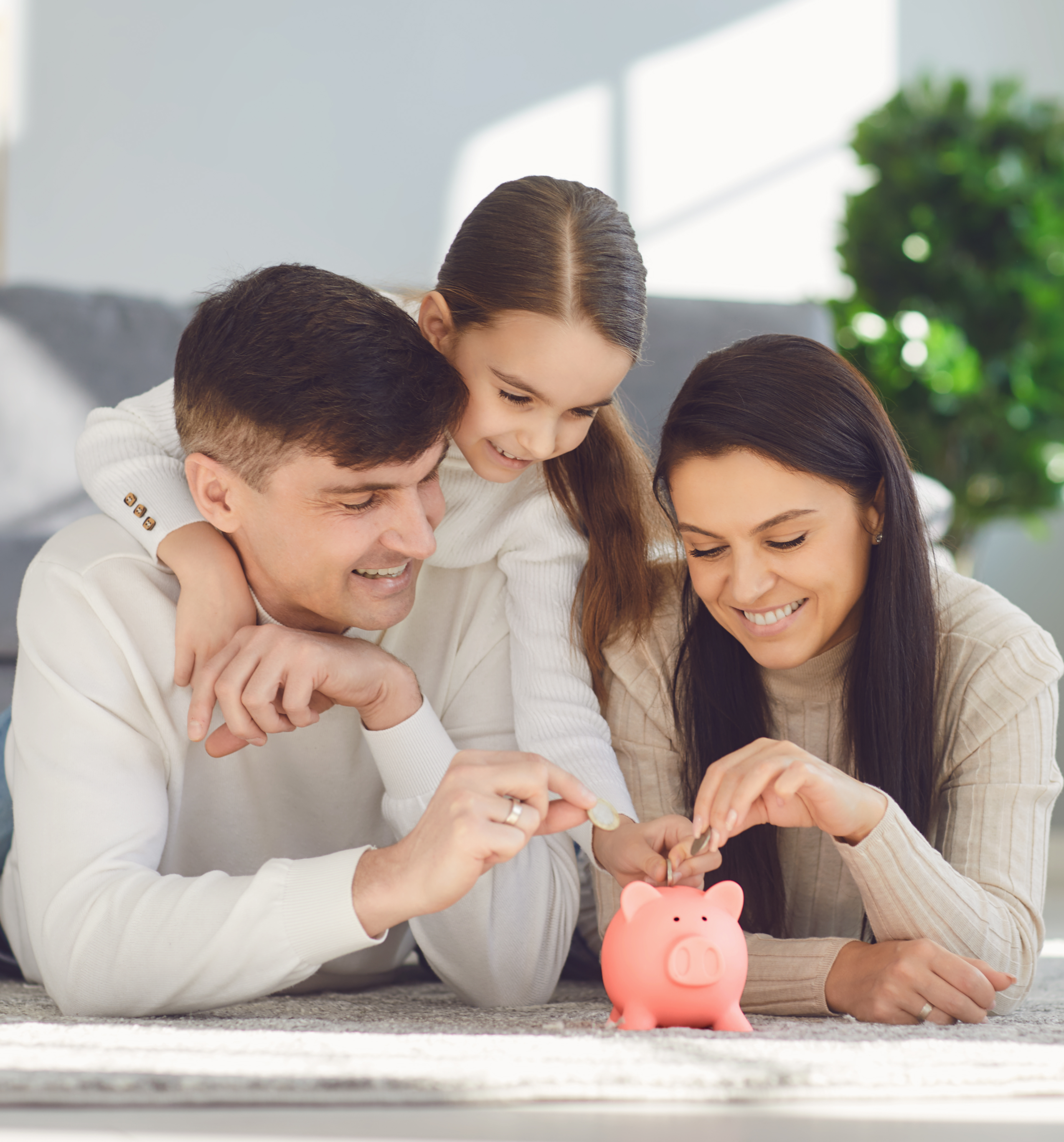 Family adding money to a piggy bank