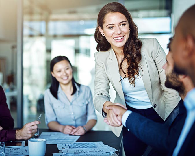 Man and woman shaking hands in a business office