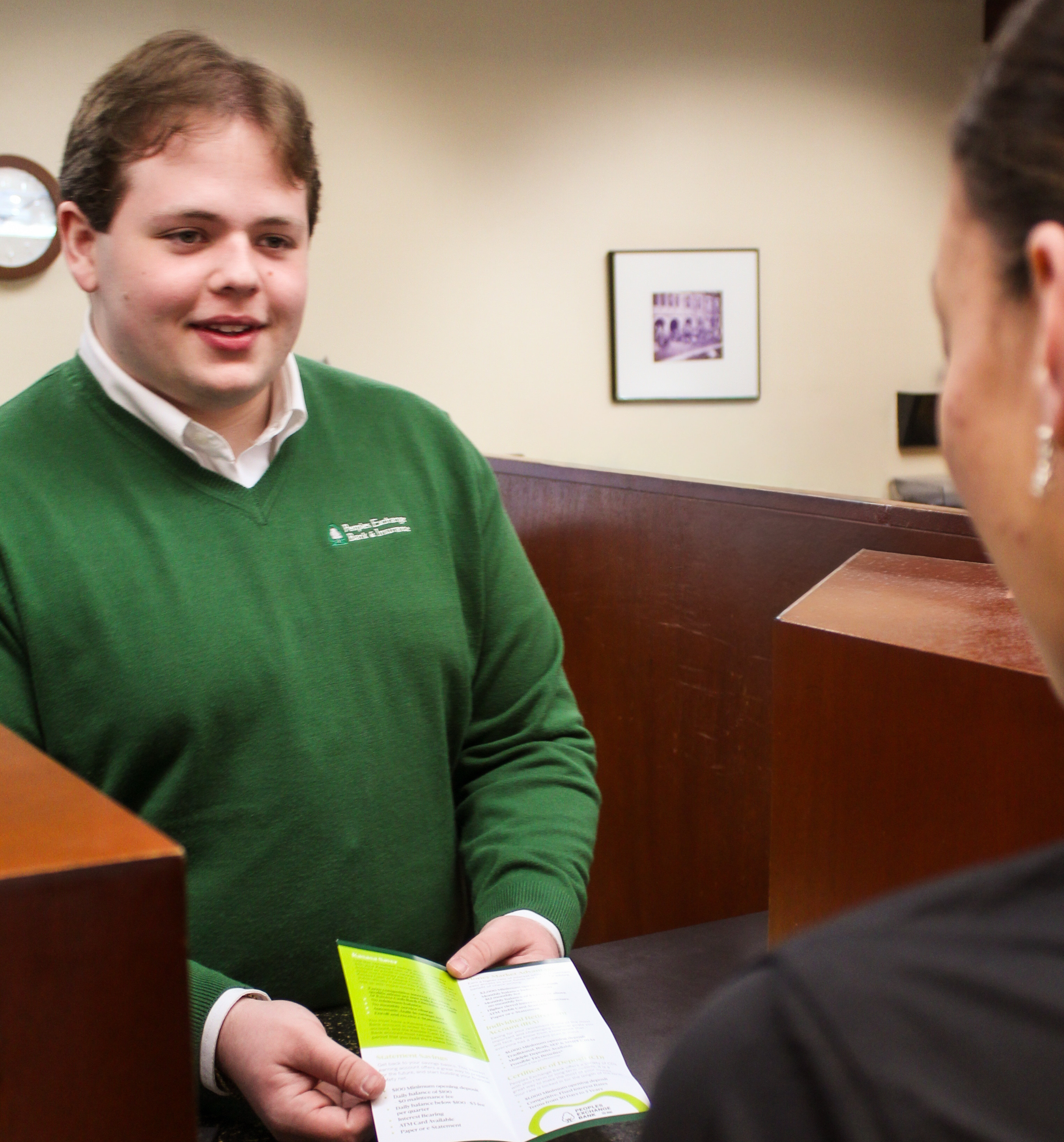 PEB employee explaining a brochure to a customer