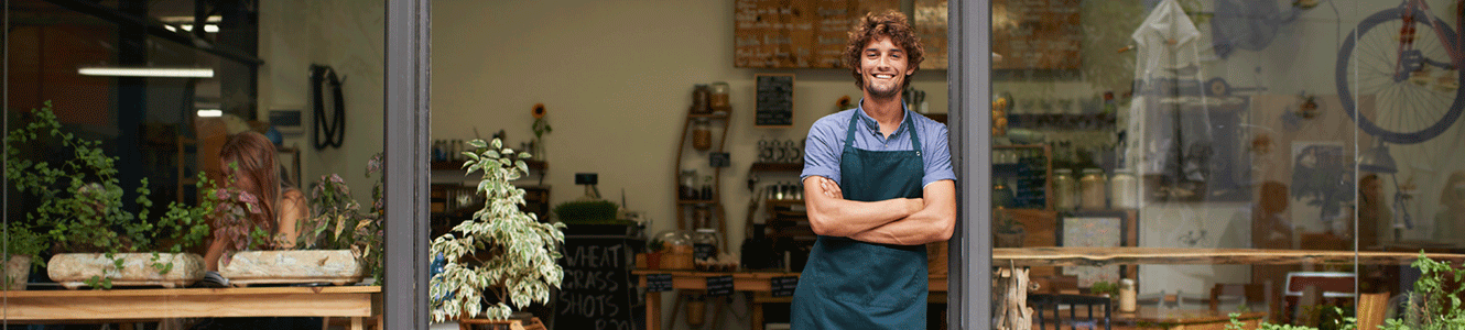 Man in open door of business